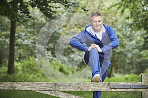 Senior Man Stretching On Countryside Run