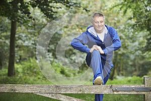 Senior Man Stretching On Countryside Run photo