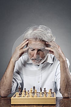 Senior man studying the chessboard photo