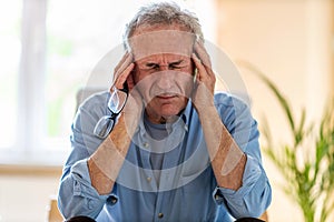 Senior man suffering from a headache