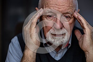 Senior man suffering from a headache
