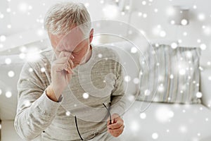 Senior man suffering from headache at home