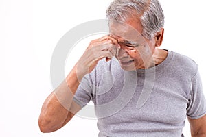 Senior man suffering from headache, stress, migraine
