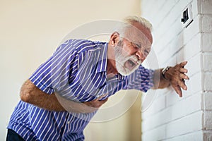 Senior man suffering from heart attack