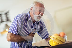 Senior man suffering from heart attack