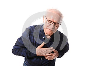 Senior man suffering from heart attack against white background