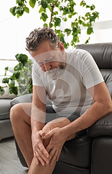 Senior man suffering from knee pain