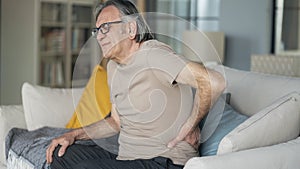 Senior man is suffering from pain in lower back at home