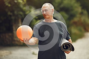 Portrait of happy handsome older man in a park photo