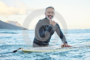 Senior man surfing in Hawaii beach, surf culture hands signal and healthy fitness in ocean nature. Friendly surfer easy