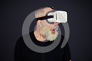 Senior man surprised using virtual reality glasses