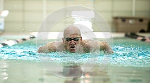 Senior man swimming competitively