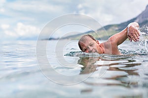 Senior man swimming in the Sea/Ocean