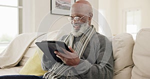 Senior man, tablet and laugh in home for reading news app, social media post or ebook in lounge. Elderly african guy