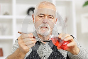 Senior man taking coughing medicin