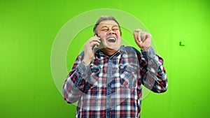 Senior man talking on mobile phone and hysterically laughing over funny joke.