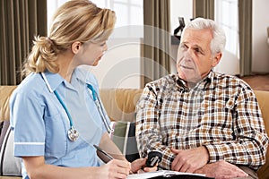 Senior Man Talking To Health Visitor photo