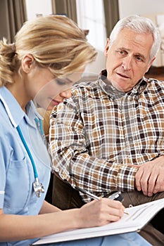 Senior Man Talking To Health Visitor photo