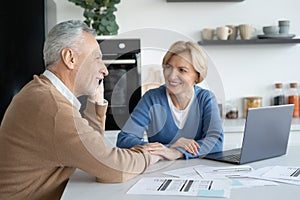 Senior man talking to phone when wife sitting next to