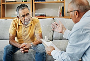 Senior man talking to a psychologist at a mental health, psychology and therapy clinic for session. Psychological