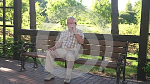 Senior man talks on phone.
