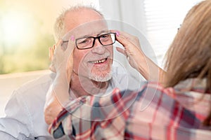 Senior man testing new eyeglasses, light effect