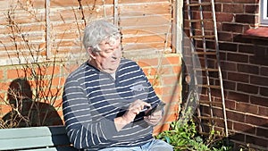 Senior man texting on a mobile phone.