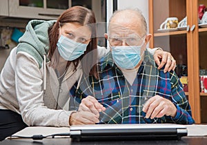 Senior Man with their Caregiver at Home during Coronavirus Pandemia photo