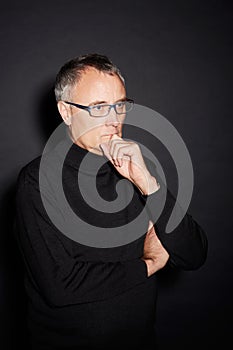 Senior man, thinking and ideas with decision, choice and confident guy on a dark studio background. Mature person