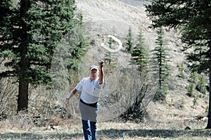 Senior man throwing horseshoe