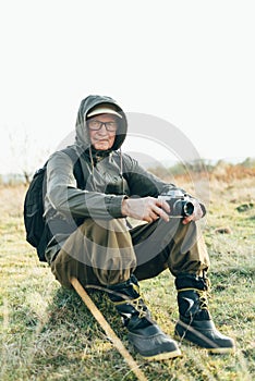 Senior man trail hiking in a mountain forest