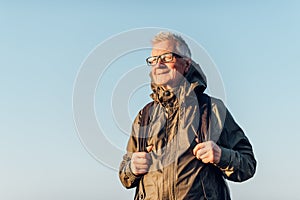 Senior man trail hiking in a mountain forest