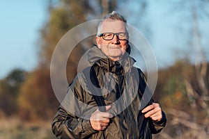 Senior man trail hiking in a mountain forest