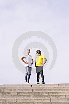 senior man and trainer posing with hands on hips