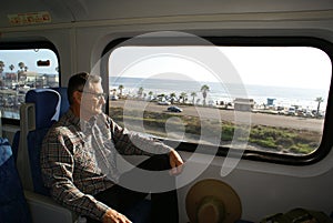 Senior Man Traveling on Train photo