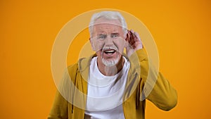 Senior man trying to hear interlocutor, health problems of aged people, deafness