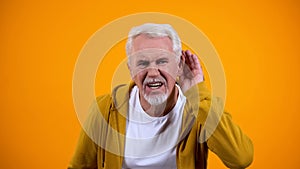 Senior man trying to hear interlocutor, health problems of aged people, deafness photo