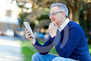 Senior man using a digital tablet outdoor