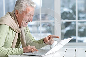 senior man using laptop