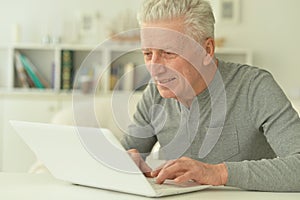 Senior man using laptop