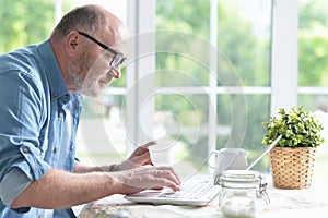 Senior man using laptop