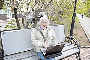 Senior man using laptop computer outdoors