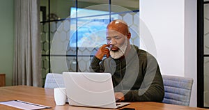 Senior man using laptop in conference room 4k