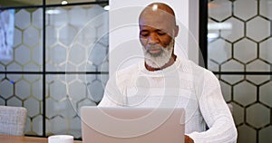 Senior man using laptop in conference room 4k