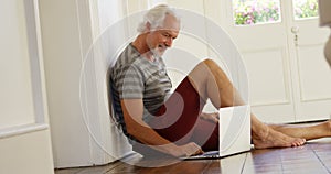 Senior man using laptop at home 4k