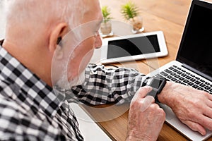 Senior man using laptop and tablet mockup