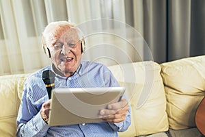 Senior man using microphone and singing karaoke