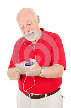 Senior Man Using MP3 Player photo