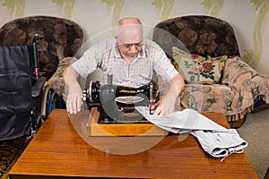 Senior Man Using Old Fashioned Sewing Machine