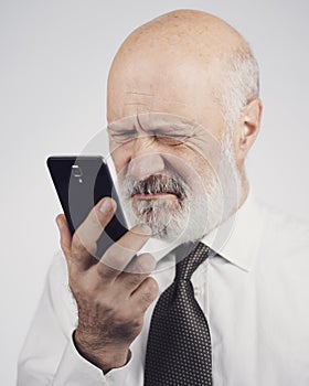 Senior man using a phone and having eyesight problems